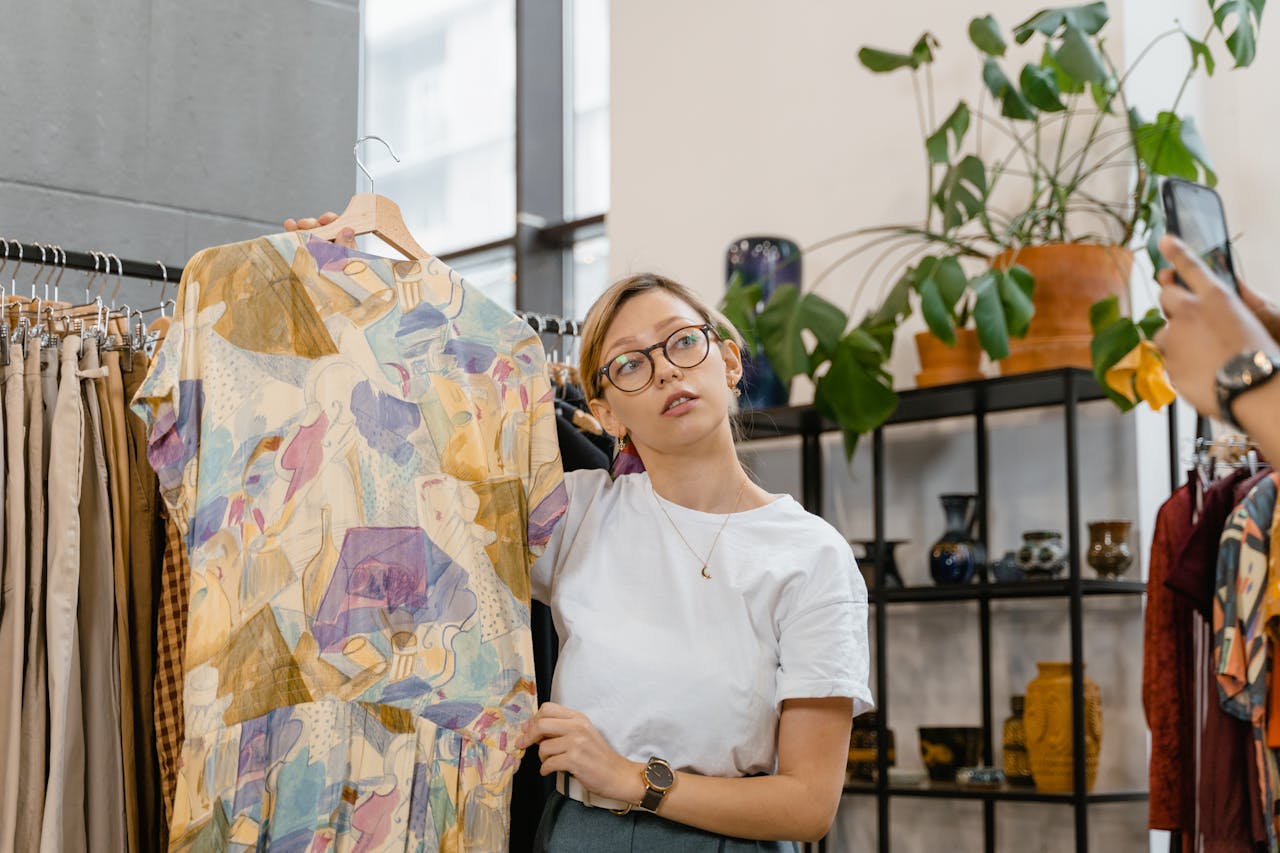 service-05 A woman showcasing a colorful dress in a stylish boutique setting, ideal for online selling.
